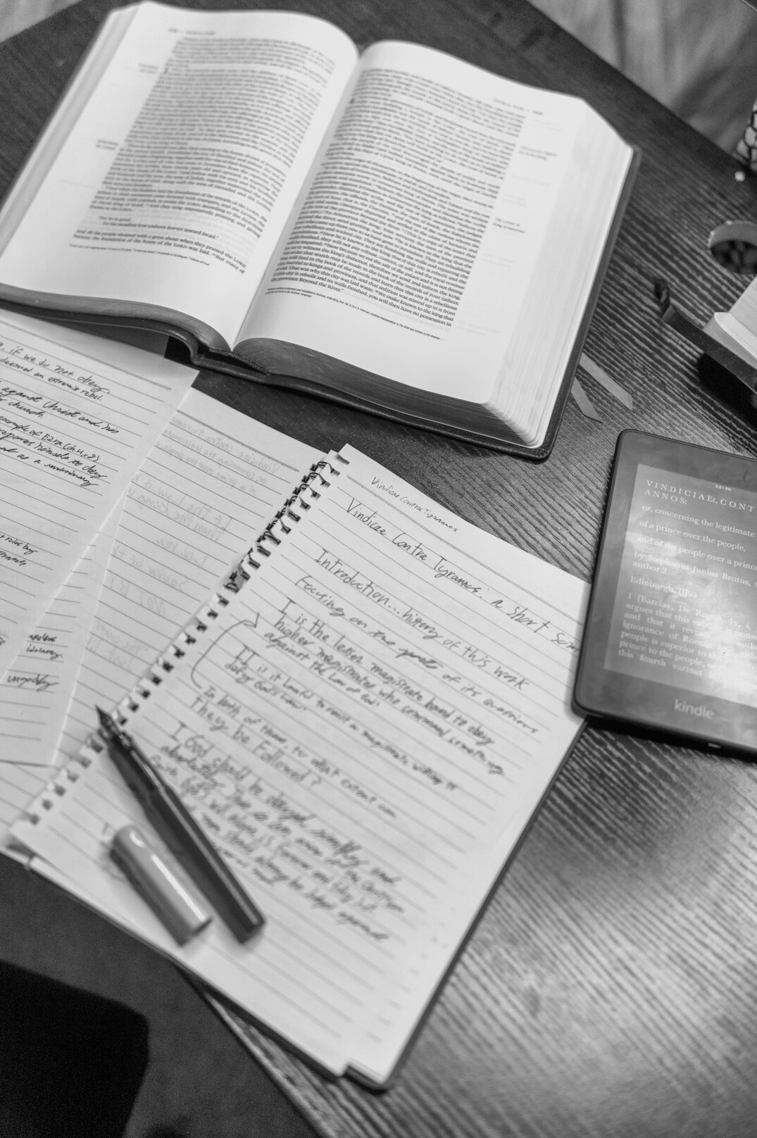 Research desk with handwritten notes, books and coffee cup